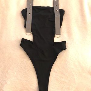 Black bodysuit. Reflective straps.